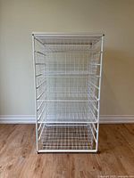 Front view of white wire organizer showing five baskets