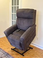 Recliner upright on lift base, remote visible