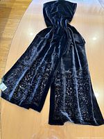 Full length view of black velvet scarf laid out on table