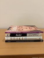 Stack of all four Reiki books showing spines