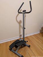 Right side view of Sunny mini stepper showing pedals, frame, handlebar, monitor