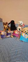 Group shot of four loose Beanie Baby dogs and three sealed Teenie Beanie bags