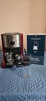 Espresso machine with accessories and boxed Ovalware cold brew maker side-by-side