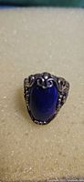Front view showing oval lapis lazuli and silver scroll design