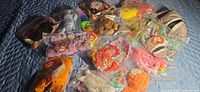 Group view of all sealed Teenie Beanie Babies on quilted surface