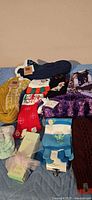 Group of eight pairs of assorted women’s socks laid out on blue quilt