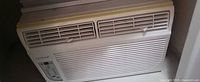 Front view of Noma window air conditioner showing vents, brand logo, control panel, yellowed plastic