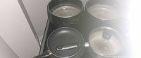 Four cookware pieces on stovetop
