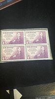 Front view of 1934 violet 3¢ Mothers of America stamp block of four