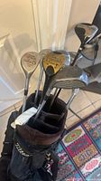 Top view of Titleist bag containing assorted vintage golf clubs