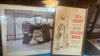 Framed print of hockey goalie and framed exhibition poster