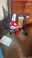 Lot overview showing folded pen with carrier, apparel, toys, pads, bags
