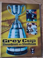 Front cover of 1996 Grey Cup program with trophy and player images