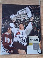 Front of signed 8x10 photo showing Rob Blake lifting Stanley Cup, signature and hologram visible