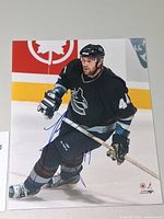 Full view of signed 8x10 photo showing player and autograph