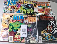 Top view showing all seven comics: X-Men #3, five Hulk issues, and bagged Deathstroke