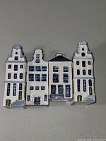 Front view of four Delft Blue miniature houses