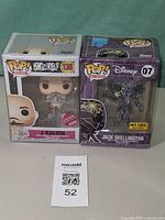 Front view of both boxed Funko Pop figures