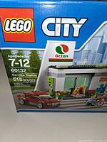Front corner view of sealed LEGO City Service Station box showing age range, set number, piece count