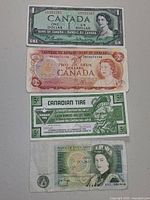 Fronts of four paper currency items laid out vertically