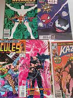 All four bagged single-issue comics laid out