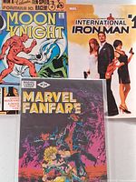 Front covers of Moon Knight, International Iron Man, Marvel Fanfare
