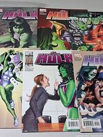 Six She-Hulk comics laid out