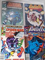 Group shot of four comic book covers: Darkhawk, The Punisher (two issues), Spider-Man team-up