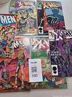 All six comic books laid out front covers visible