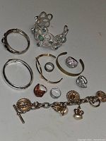 Entire lot overview showing bracelets, cuffs, rings and charm bracelet