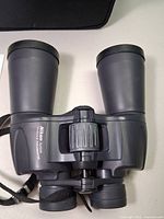 Front view of Nikon Action 12x50 binoculars showing objective lenses and body
