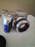 Front view of Olympus SP-510UZ camera showing lens, 7.1 MP and 10× zoom labels