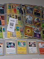 Binder pages filled with Pokémon cards and sleeved singles