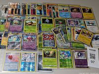 Spread of assorted Pokémon cards, reverse holos and non-holos