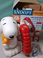 Snoopy phone base, red handset, cords and original box displayed
