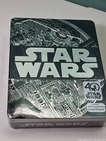 Front of sealed Star Wars 40th Anniversary tin showing Death Star artwork