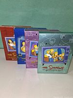 Front view of all four Simpsons collector’s edition DVD box sets