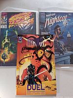 Front covers of all three bagged comics