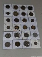 Overall view of approximately 24 coin flips arranged on table