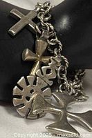 Bracelet close-up showing mixed metal charms