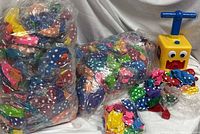 Two large bags of polka-dot balloons and pump grouped