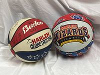 Both signed Baden basketballs showing team logos and signatures