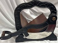 Front view showing cast iron frame, steel blade, wood handle