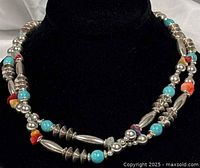 Necklace draped on black velvet bust, showing bead arrangement