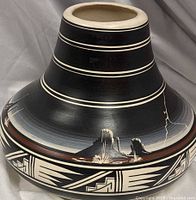 Oblique view showing etched desert scene and geometric border