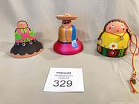 Front view of all three clay bell ornaments