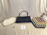 Three handbags side by side displaying size and style