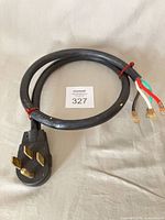 Entire cord coiled, showing plug and lead ends