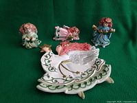 Group shot of angel plate with three figurines