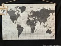 Full view of hanging canvas world map showing overall design and rope hanger